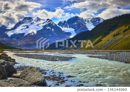 Athabasca Glacier River Flow with Snow Capped Mountain Peaks and Rocky Slopes 136144060