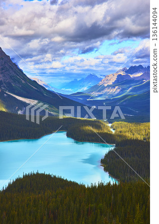 Peyto Lake Vibrant Blue Water Surrounded by Pine Forest and Rocky Mountain Peaks Peyto Lake Vibrant Blue Water Surrounded by Pine Forest and Rocky Mountain Peaks 136144094
