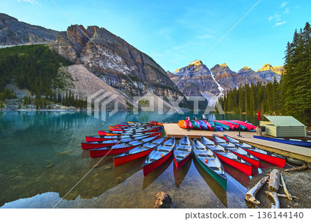 Lake Moraine Sunrise Canoes on Crystal Water and Mountain Reflections in Banff Lake Moraine Sunrise Canoes on Crystal Water and Mountain Reflections in Banff 136144140