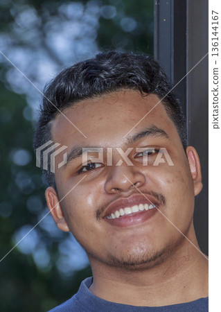 portrait of a young man smiling portrait of a young man smiling 136144167