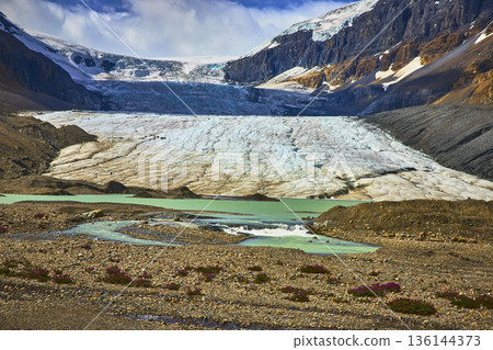 Athabasca Glacier and Turquoise Meltwater with Rugged Mountain Peaks in Jasper Athabasca Glacier and Turquoise Meltwater with Rugged Mountain Peaks in Jasper 136144373