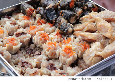 Assorted Indonesian Street Food Display, Siomay, Dumplings, and Rolls, showcasing culinary diversity and traditional flavors for local cuisine promotion 136144494