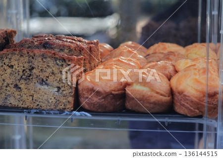 Indonesian Street Food Display: Sweet Breads and Cakes in Glass Case, Natural Light, Jajanan Tradisional, Delicious Indonesian Culinary Delights Indonesian Street Food Display: Sweet Breads and Cakes in Glass Case, Natural Light, Jajanan Tradisional, Delicious Indonesian Culinary Delights 136144515