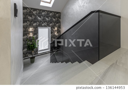 Modern staircase with glass railing and decorative elephant wallpaper 136144953