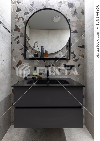 Modern Bathroom Vanity with Round Mirror and Terrazzo Tiles Modern Bathroom Vanity with Round Mirror and Terrazzo Tiles 136144956
