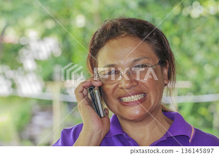 senior woman talking on mobile phone 136145897