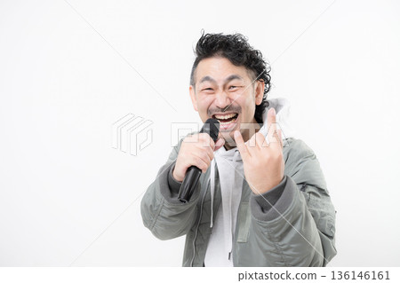 A man holding a microphone and shouting, singing rock or heavy metal 136146161