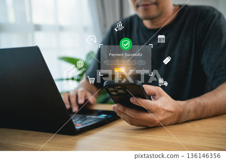 Man using smartphone for mobile payment with virtual successful transaction interface and e-commerce technology icons for secure online shopping concept 136146356