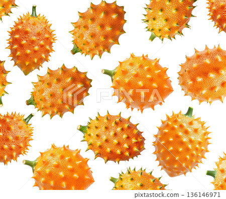 Multiple horned orange kiwano fruits with green tips isolated on white background, concept of exotic fruit freshness Multiple horned orange kiwano fruits with green tips isolated on white background, concept of exotic fruit freshness 136146971