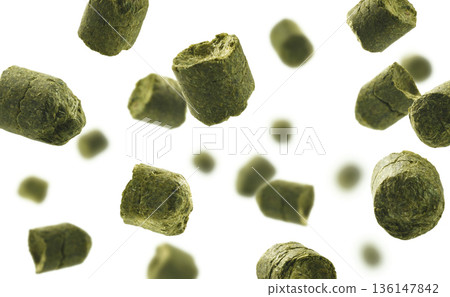 Dynamic image of hop pellets. Suspended hop pellets with aromatic essence. Floating green hops emphasizing freshness and fragrant aroma qualities Dynamic image of hop pellets. Suspended hop pellets with aromatic essence. Floating green hops emphasizing freshness and fragrant aroma qualities 136147842