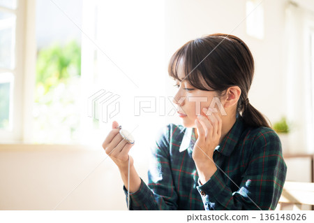 Woman looking at pocket watch 136148026