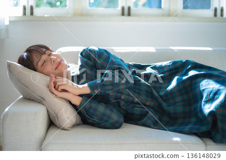 Woman taking a nap on the couch Woman taking a nap on the couch 136148029