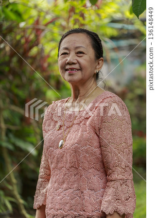 portrait of smiling woman in garden 136148449
