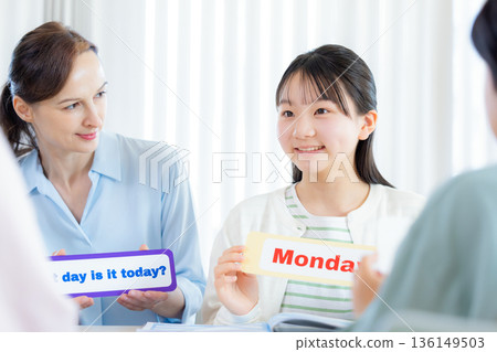 Education A child taking a lesson in an English conversation class and a native teacher 136149503