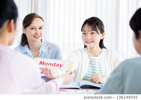 Education A child taking a lesson in an English conversation class and a native teacher 136149545