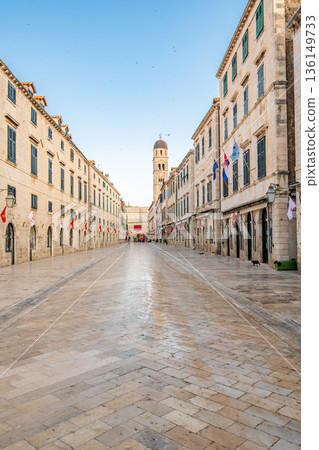Dubrovnik main street - Strada street. Main shopping street in old city of Dubrovnik. Morning time during the sunset, soft light and warm colors. Ancient city, part of UNESCO heritage. 136149733