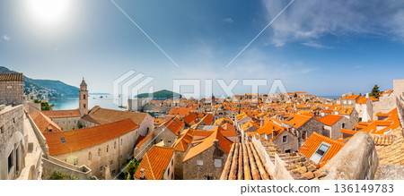 Aerial panoramic view of old city Dubrovnik. Ancient city with big city walls near adriatic sea. View of roofs, sunny summer day. Aerial panoramic view of old city Dubrovnik. Ancient city with big city walls near adriatic sea. View of roofs, sunny summer day. 136149783