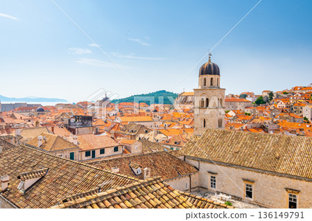 Aerial panoramic view of old city Dubrovnik. Ancient city with big city walls near adriatic sea. View of roofs, sunny summer day. Aerial panoramic view of old city Dubrovnik. Ancient city with big city walls near adriatic sea. View of roofs, sunny summer day. 136149791