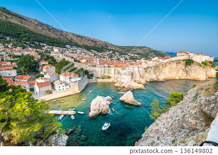Old city Dubrovnik panorama. View of town roofs, cliff above the sea and small harbor with boats. 136149802