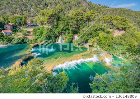 Waterfalls at Krka river, Croatia. Part of the Skradinski Buk waterfall. Famous place in nature park - beautiful tourist destination in Croatia. Fresh green nature, summer weather. 136149809