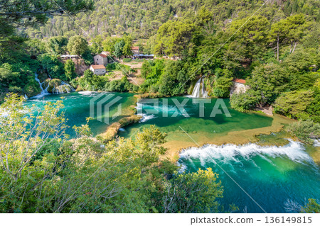 Waterfalls at Krka river, Croatia. Part of the Skradinski Buk waterfall. Famous place in nature park - beautiful tourist destination in Croatia. Fresh green nature, summer weather. 136149815