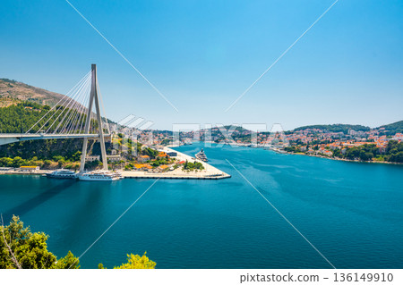 Panoramic view of the new harbor at Dubrovnik city, Croatia. View with bridge on left side. Blue sea, summer weather. 136149910