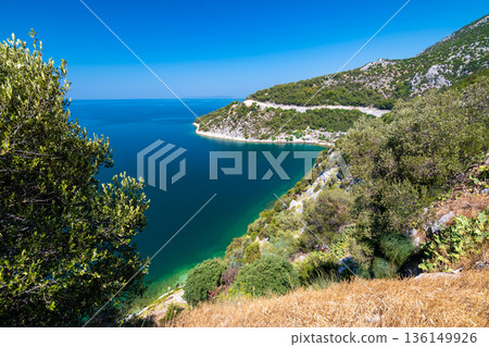 View of beautiful Croatia coast near Makarska. Blue sea with white beach. Isles in the background. Summer weather, blue sky. 136149926