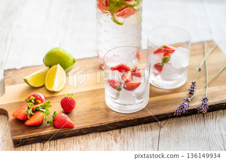 Fresh drink with strawberry and lime placed on wooden desk. Glasses with lemonade and ice. Summer drink. Fresh drink with strawberry and lime placed on wooden desk. Glasses with lemonade and ice. Summer drink. 136149934