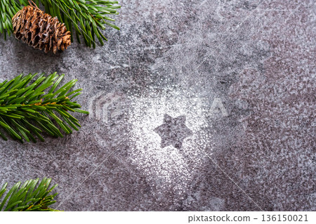 Pine cone is placed on gray background with green pine tree branch. Winter and christmas decoration. Pine cone is placed on gray background with green pine tree branch. Winter and christmas decoration. 136150021