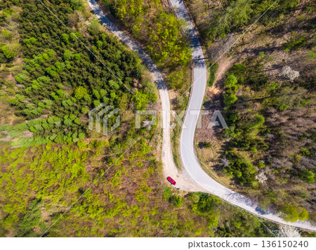 Aerial top down drone view of curve road in the forest. Aerial top down drone view of curve road in the forest. 136150240