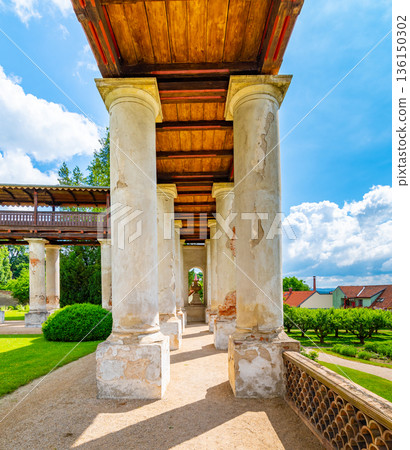 Lysice castle, Czech Republic. Famous baroque castle built in 14th century. Beautiful formal garden, palm trees and flowers. Promenade near the castle. Sunny day, dramatic clouds before storm. Lysice castle, Czech Republic. Famous baroque castle built in 14th century. Beautiful formal garden, palm trees and flowers. Promenade near the castle. Sunny day, dramatic clouds before storm. 136150302
