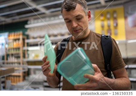 Man shopping for food containers Man shopping for food containers 136150335