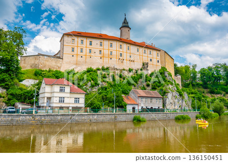 Panoramic view of castle above river in Ledec nad Sazavou. Sazava river is famous target for kayaking. Summer weather with dramatic clouds. Czech Republic. Panoramic view of castle above river in Ledec nad Sazavou. Sazava river is famous target for kayaking. Summer weather with dramatic clouds. Czech Republic. 136150451
