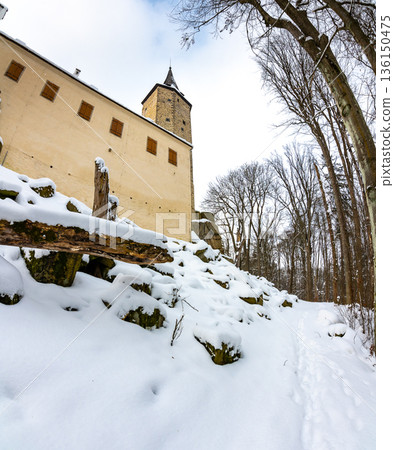 Medieval castle Rostejn in winter during snowfalling. Castle is placed in deep forest near Telc city. Winter and snow, beautiful nature. Medieval castle Rostejn in winter during snowfalling. Castle is placed in deep forest near Telc city. Winter and snow, beautiful nature. 136150475