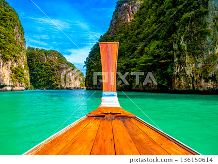 View of Pi Leh lagoon (also known as Green Lagoon) at Ko Phi Phi islands, Thailand. View from typical long tailed boat. Typical Thai picture of tropical paradise. Limestone rock and turquoise water. View of Pi Leh lagoon (also known as Green Lagoon) at Ko Phi Phi islands, Thailand. View from typical long tailed boat. Typical Thai picture of tropical paradise. Limestone rock and turquoise water. 136150614