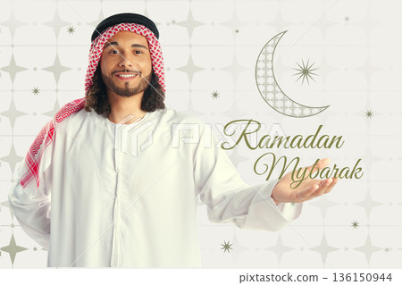Man celebrating Ramadan in traditional dress with festive decorations in the background 136150944