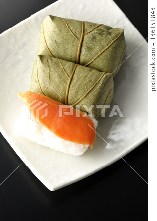 Salmon and oyster sushi photographed against a black background Salmon and oyster sushi photographed against a black background 136151843