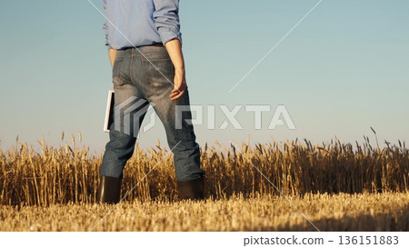 man wearing blue jeans blue shirt standing field. holding book hand, Business growth through smart farming, Data driven decisions agriculture, Precision farming with tablets, Efficiency wheat man wearing blue jeans blue shirt standing field. holding book hand, Business growth through smart farming, Data driven decisions agriculture, Precision farming with tablets, Efficiency wheat 136151883