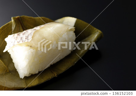 Sea bream oyster sushi photographed against a black background Sea bream oyster sushi photographed against a black background 136152103