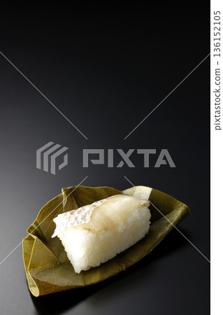 Sea bream oyster sushi photographed against a black background 136152105