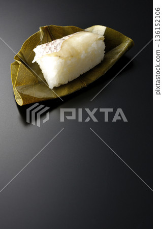 Sea bream oyster sushi photographed against a black background 136152106