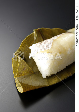 Sea bream oyster sushi photographed against a black background Sea bream oyster sushi photographed against a black background 136152110