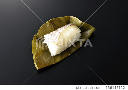 Sea bream oyster sushi photographed against a black background Sea bream oyster sushi photographed against a black background 136152112