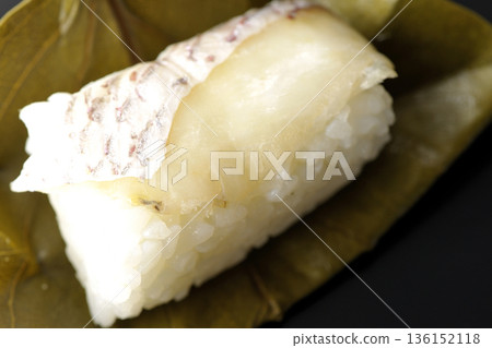 Sea bream oyster sushi photographed against a black background Sea bream oyster sushi photographed against a black background 136152118