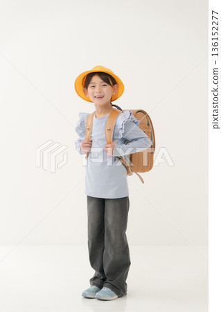 Girls carrying a school bag 136152277