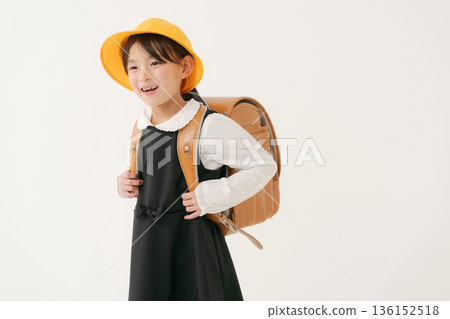 Girls carrying a school bag Girls carrying a school bag 136152518