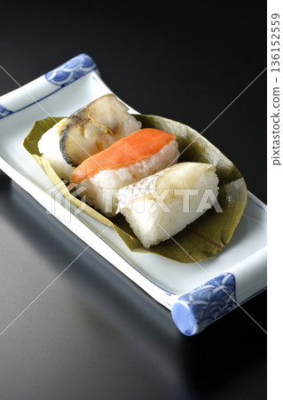 Salmon, sea bream and mackerel persimmon leaf sushi photographed against a black background Salmon, sea bream and mackerel persimmon leaf sushi photographed against a black background 136152559