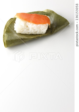 Salmon persimmon leaf sushi photographed on white background 136153058