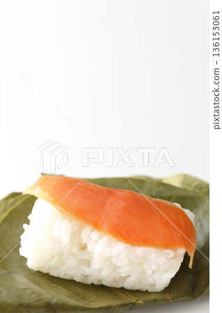 Salmon persimmon leaf sushi photographed on white background 136153061