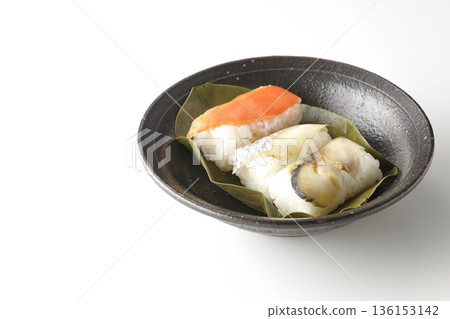 Salmon, sea bream and mackerel persimmon leaf sushi photographed on a white background Salmon, sea bream and mackerel persimmon leaf sushi photographed on a white background 136153142